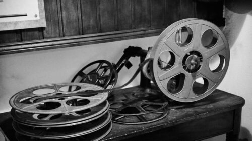 Vintage Film Reels and Old Cinema Projector 4K Wallpaper