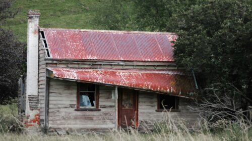 Abandoned Rustic Wooden Cottage in Rolling Hills Desktop Wallpaper