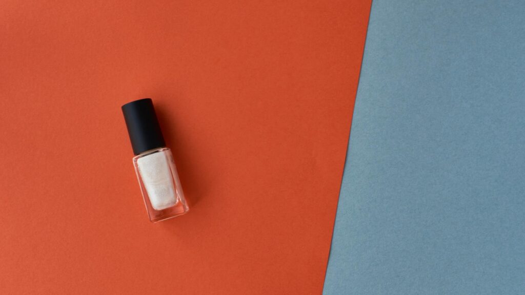 Minimalist Pearl White Nail Polish on Geometric Orange and Blue Desktop Wallpaper