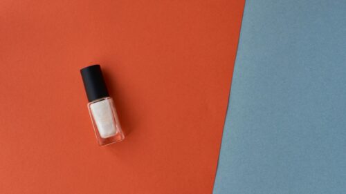 Minimalist Pearl White Nail Polish on Geometric Orange and Blue Desktop Wallpaper
