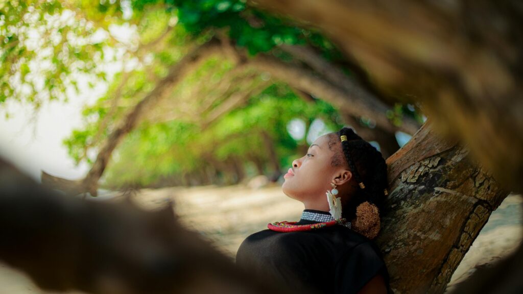 Woman Resting Against Tree on Beach Tropical Paradise 4K Wallpaper