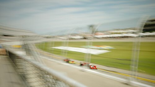 Blurred Race Cars on High Speed Track 4K Desktop Wallpaper