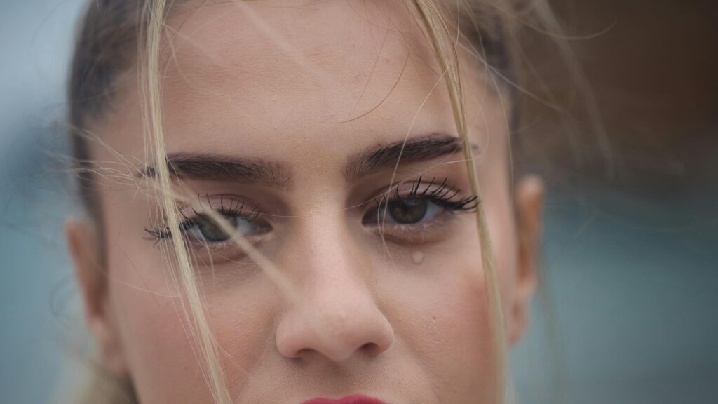Sad Blonde Girl Crying with Windblown Hair Close-up 4K Desktop Wallpaper