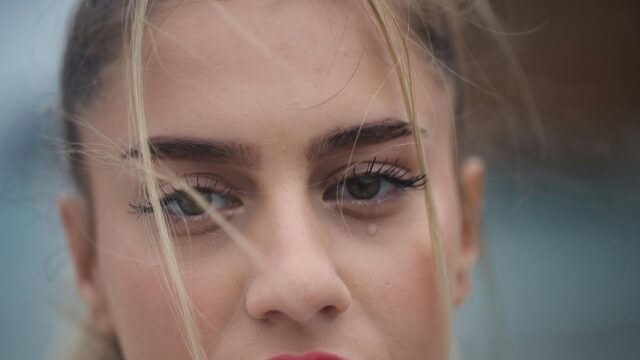 Sad Blonde Girl Crying with Windblown Hair Close-up 4K Desktop Wallpaper