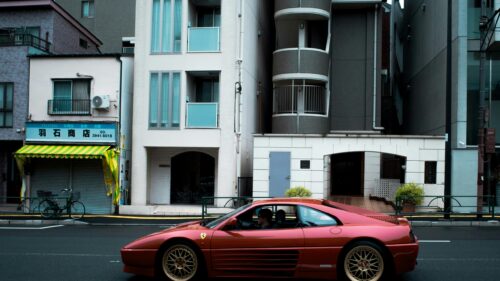 Stunning Classic Red Ferrari 348 Sports Car on Tokyo Street 4K Wallpaper