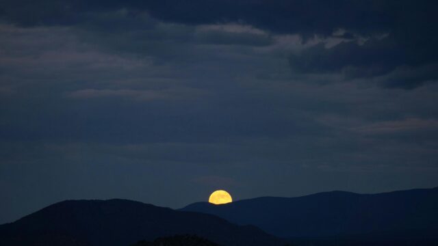 Golden Full Moon Rising Over Dark Silhouette Mountains Desktop Wallpaper