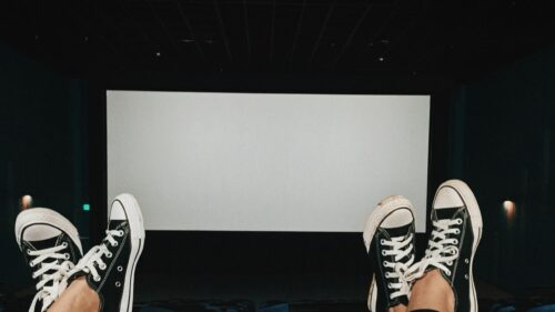 POV Perspective in Movie Theater with Converse Sneakers Desktop Wallpaper