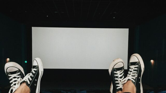 POV Perspective in Movie Theater with Converse Sneakers Desktop Wallpaper