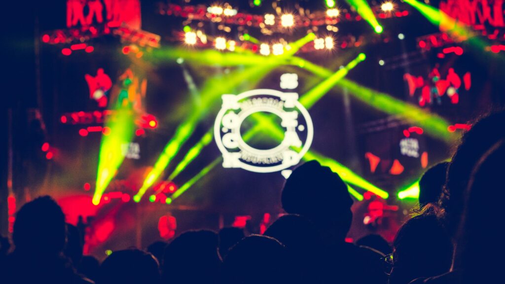 Vibrant Concert Stage Lights and Crowd Silhouette 4K Wallpaper
