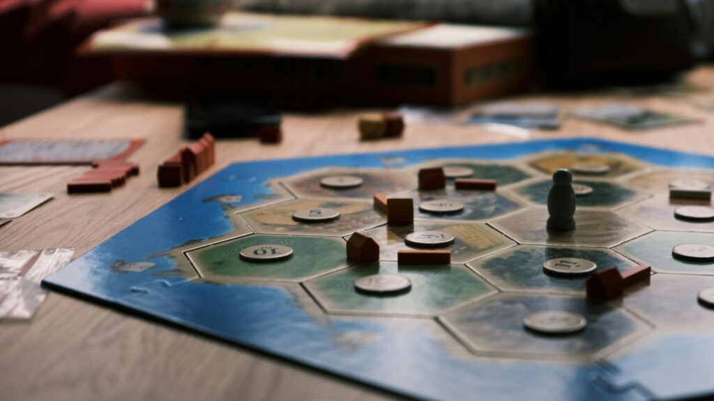 Catan Board Game Pieces on Wooden Table High-Res Desktop Wallpaper