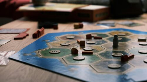 Catan Board Game Pieces on Wooden Table High-Res Desktop Wallpaper