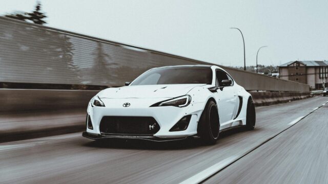 Modified White Toyota 86 Widebody Sportscar on Highway 4K Desktop Wallpaper