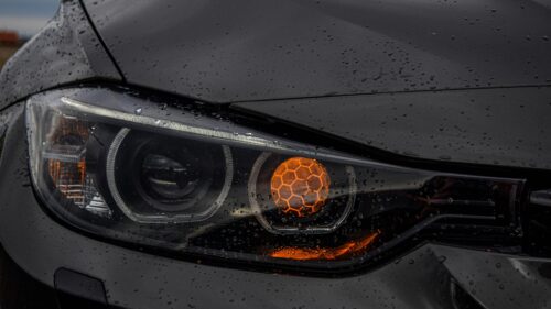 Close-up BMW Headlight with Honeycomb Amber Detail 4K Wallpaper