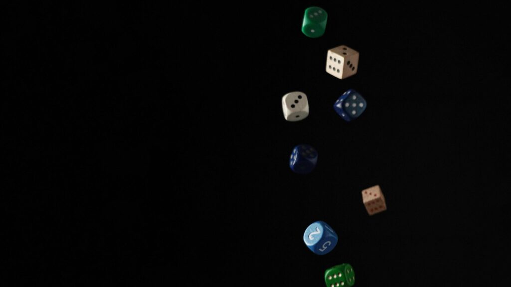 Floating Colorful Game Dice on Black Background 4K Wallpaper