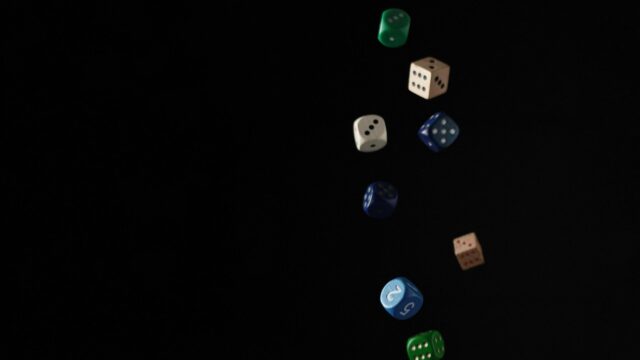 Floating Colorful Game Dice on Black Background 4K Wallpaper