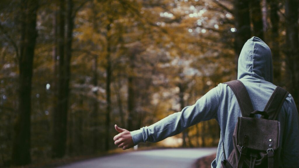 Hitchhiker Alone on a Forest Road 4K Desktop Wallpaper