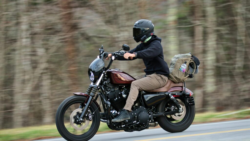 Harley-Davidson Sportster Riding on Open Road 4K Wallpaper