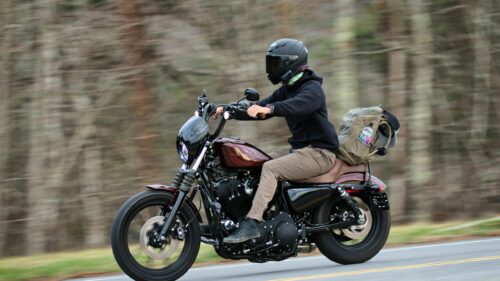 Harley-Davidson Sportster Riding on Open Road 4K Wallpaper
