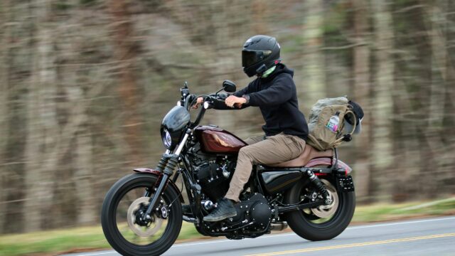 Harley-Davidson Sportster Riding on Open Road 4K Wallpaper