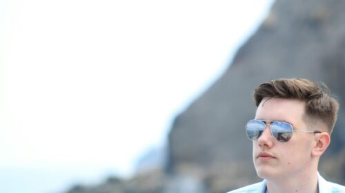 Cool Young Man in Aviator Sunglasses Minimalist Desktop Wallpaper