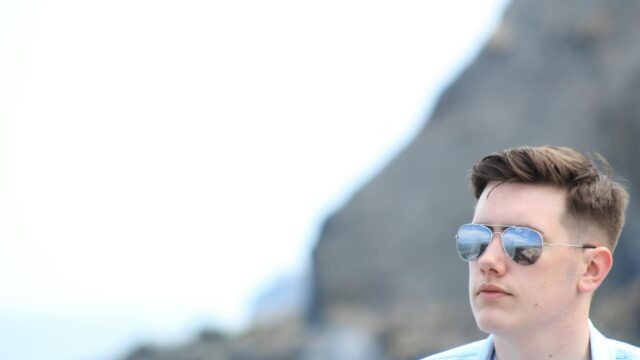 Cool Young Man in Aviator Sunglasses Minimalist Desktop Wallpaper