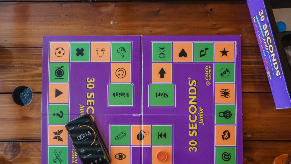 Top-Down View of 30 Seconds Junior Board Game on Rustic Wooden Table 4K Wallpaper