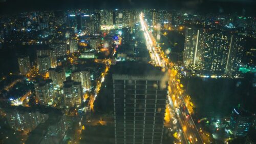 Night City Skyline Aerial View with Glowing Street Lights 4K Wallpaper