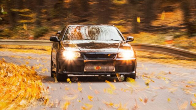 Nissan Skyline GT-R R34 Driving Through Autumn Leaves 4K Wallpaper