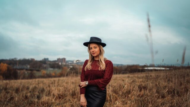 Blonde Woman in Burgundy Polka Dot Blouse Fedora Hat Desktop Wallpaper