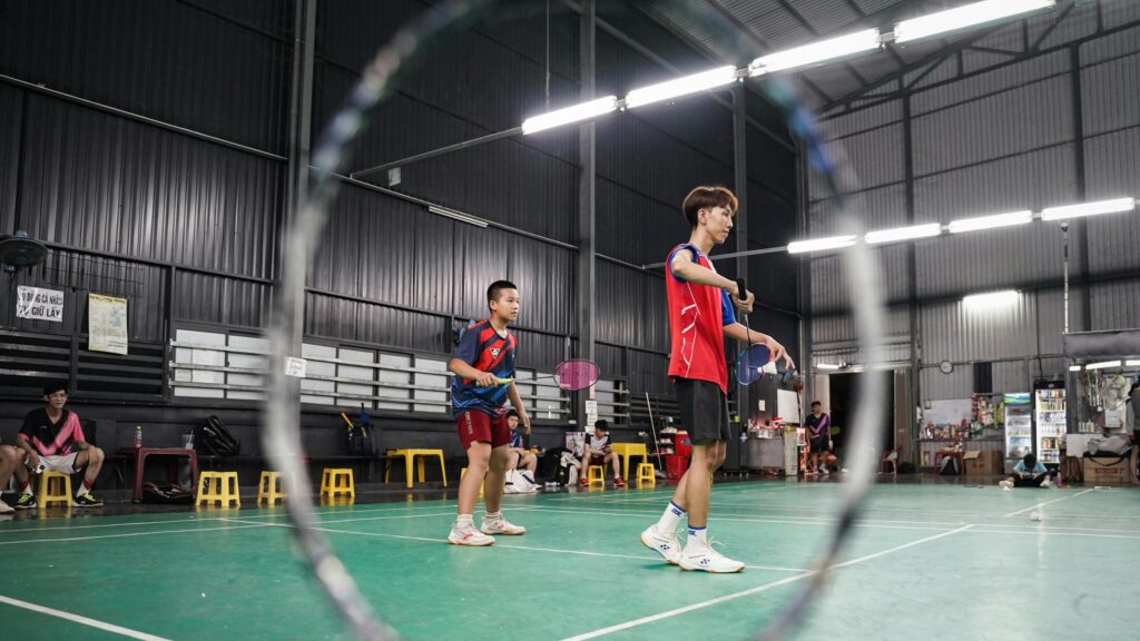 Badminton Players Practicing on Indoor Court 4K Wallpaper