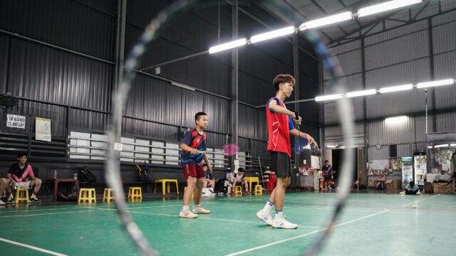 Badminton Players Practicing on Indoor Court 4K Wallpaper