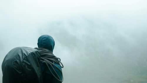Solo Hiker Standing in Misty Mountain Fog 4K Wallpaper