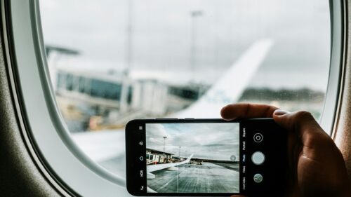 Traveler Capturing Airplane Wing View 4K Desktop Wallpaper
