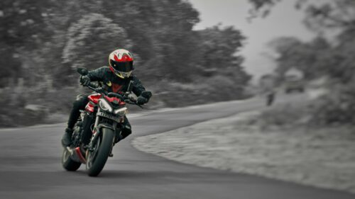 Triumph Street Triple Red Motorcycle Racing Through A Scenic Bend 4K Wallpaper