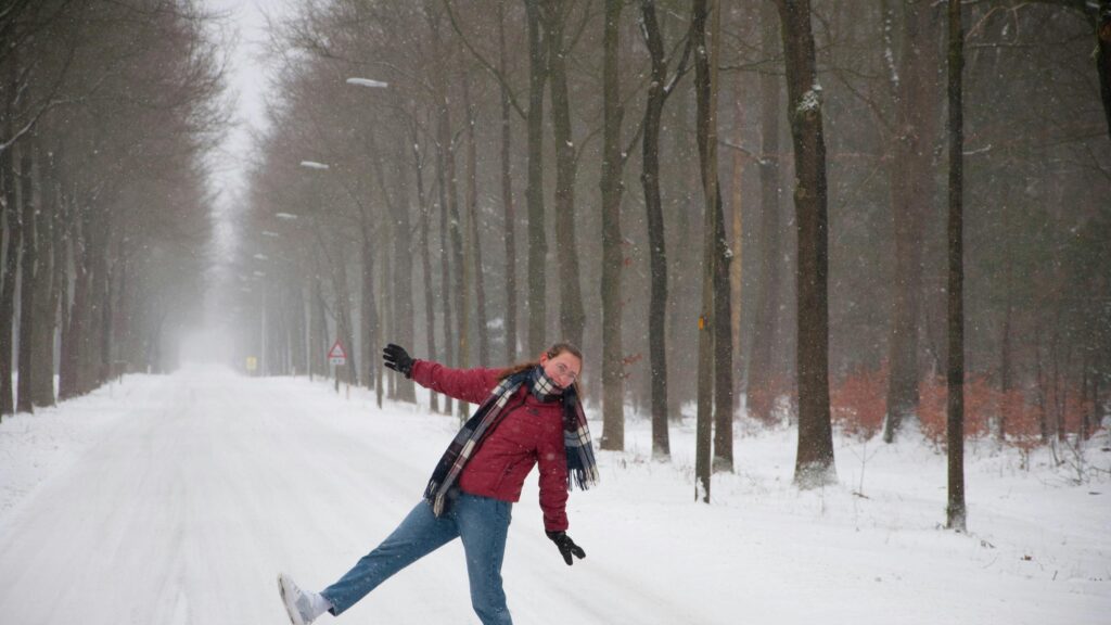 Woman Having Fun in Snowy Forest Road Desktop Wallpaper