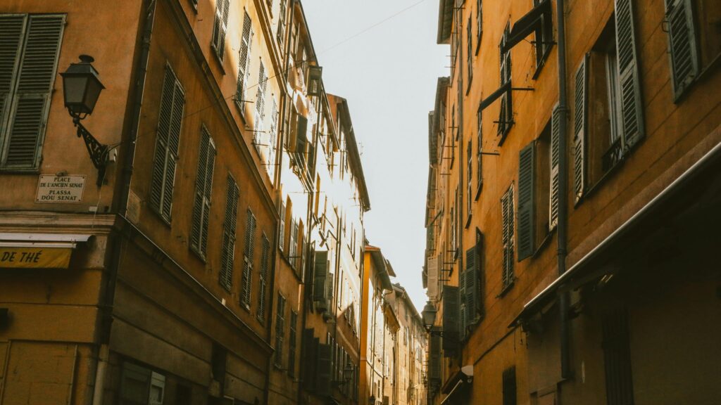 Charming Old Town Street with Yellow Buildings Desktop Wallpaper