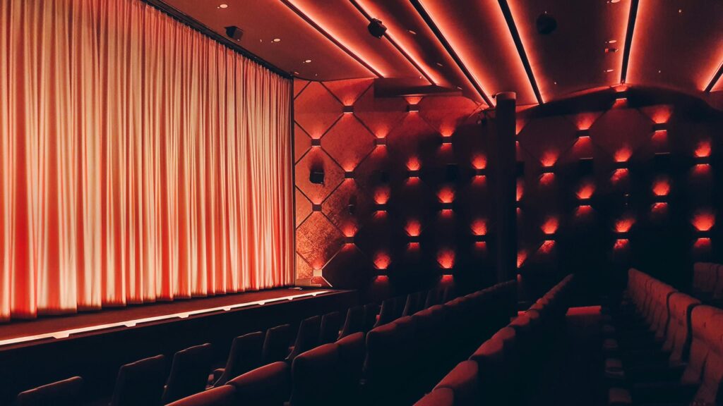 Cinematic Empty Movie Theater Red Ambient Lighting 4K Desktop Wallpaper