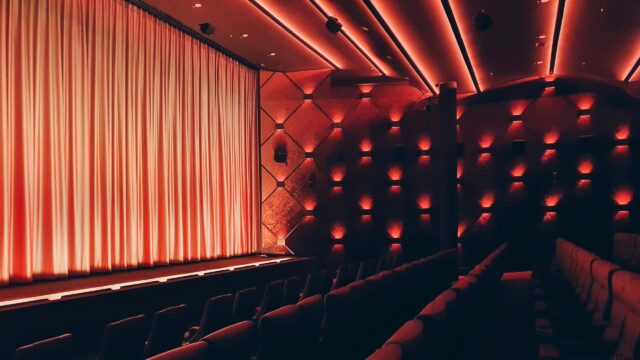 Cinematic Empty Movie Theater Red Ambient Lighting 4K Desktop Wallpaper