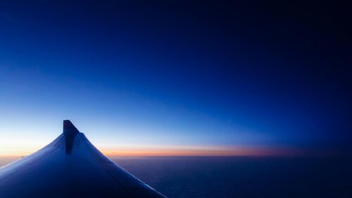 Stunning Airplane Wing at Sunrise Above Clouds Desktop Wallpaper