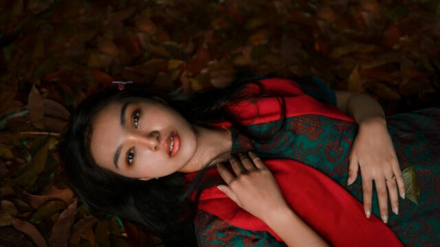 Beautiful Woman Lying on Autumn Leaves Portrait 4K Wallpaper