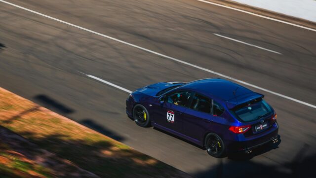 Deep Blue Subaru WRX STI Hatchback Racing on Track 4K Wallpaper