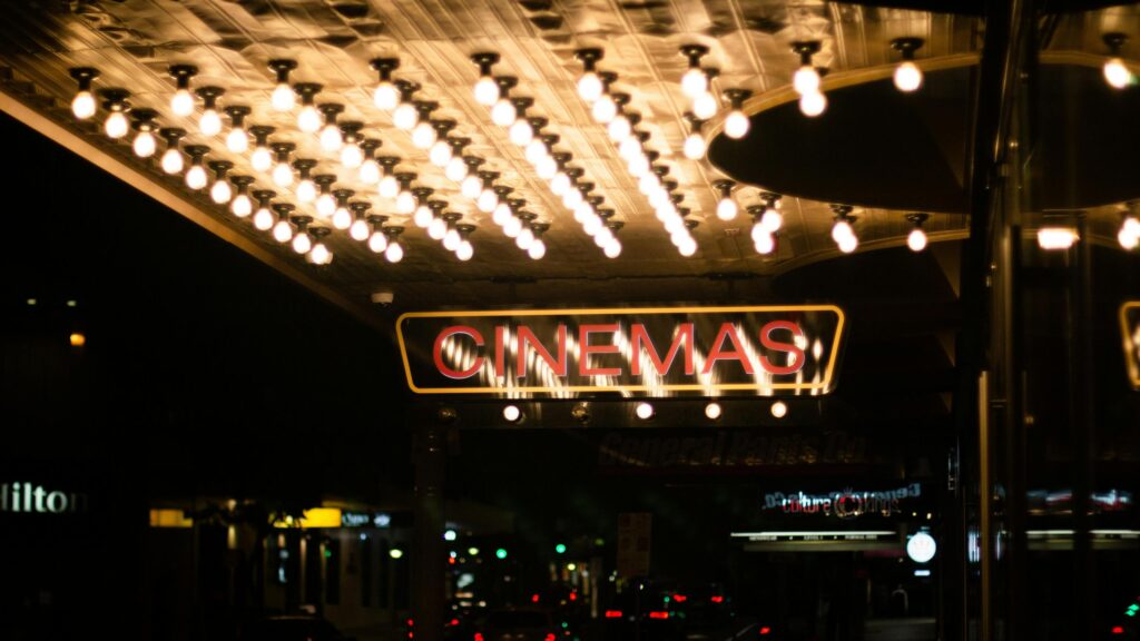 Glowing Vintage Cinema Entrance Lights Night 4K Desktop Wallpaper