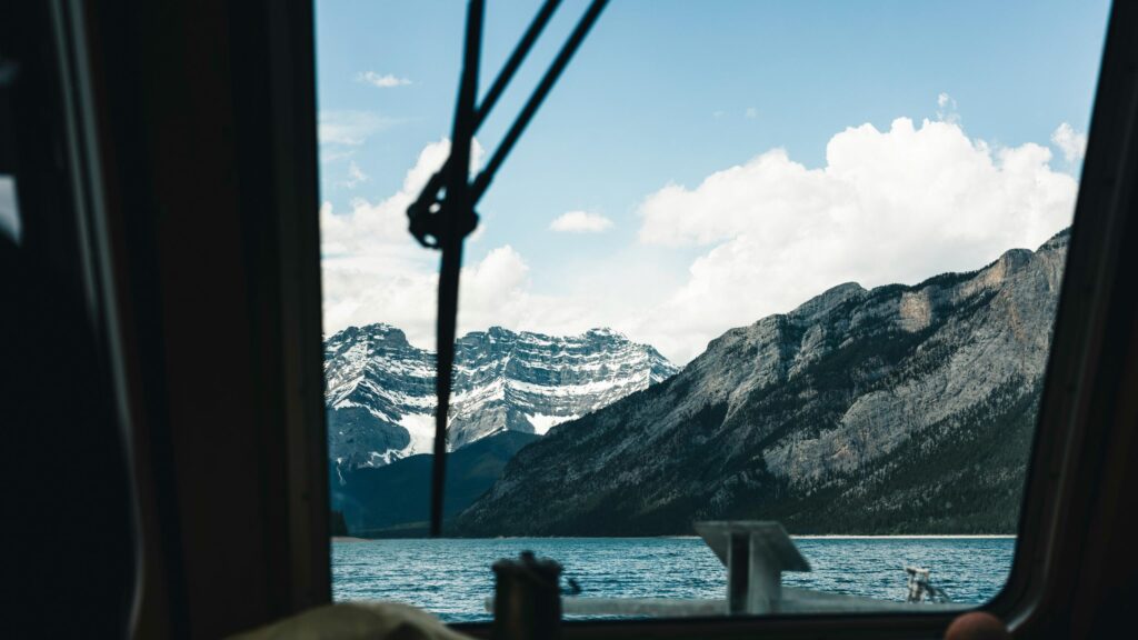 View of Snowy Canadian Rockies from a Boat 4K Wallpaper