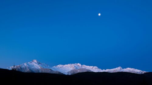Moon Over Snow Covered Mountain Peaks at Twilight Desktop Wallpaper
