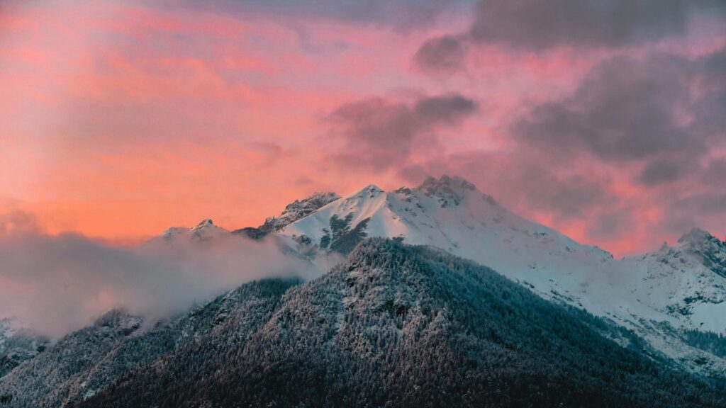 Stunning Pink Sunset Over Snowy Mountain Peaks 4K Desktop Wallpaper