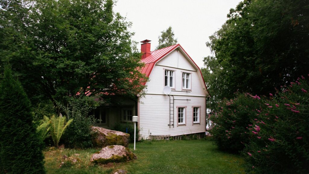 Cozy White Cottage with Red Roof in Lush Garden 4K Desktop Wallpaper