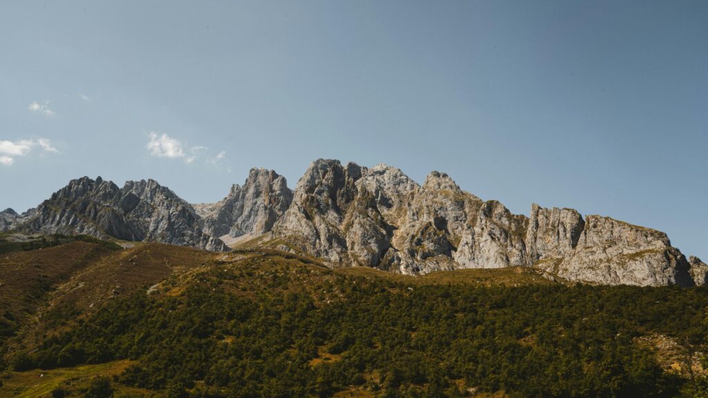 Majestic Rocky Mountain Peaks Under Clear Blue Sky 4K Desktop Wallpaper