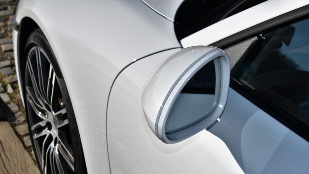 Close-up White Luxury Sports Car Side Mirror and Wheel 4K Wallpaper