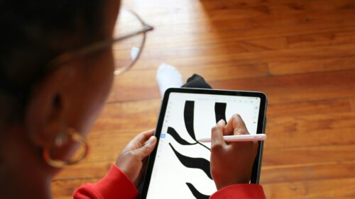 Creative Artist Sketching Abstract Art on Tablet 4K Wallpaper