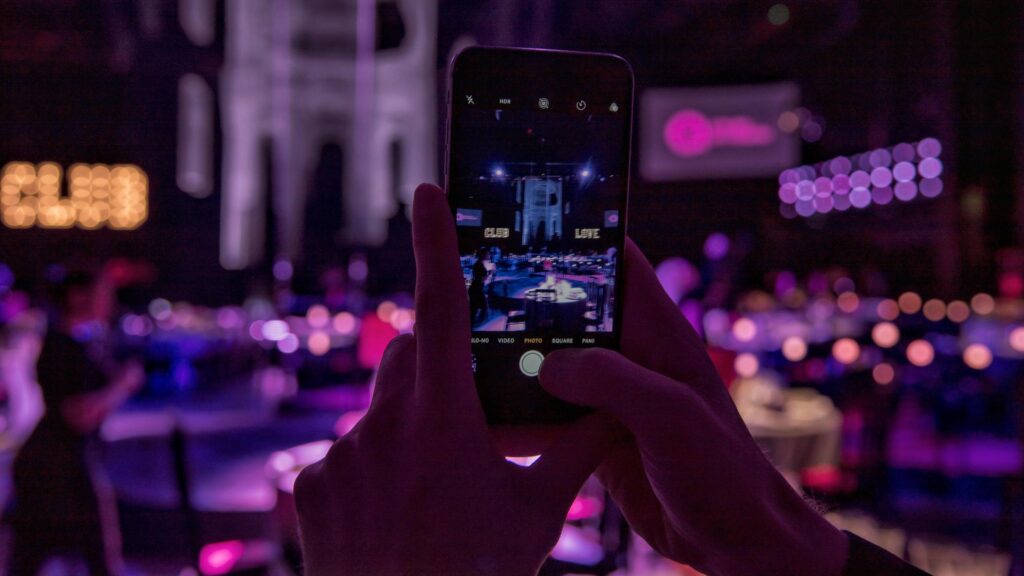 First Person View of Smartphone Taking Photo at Nightclub Party 4K Wallpaper